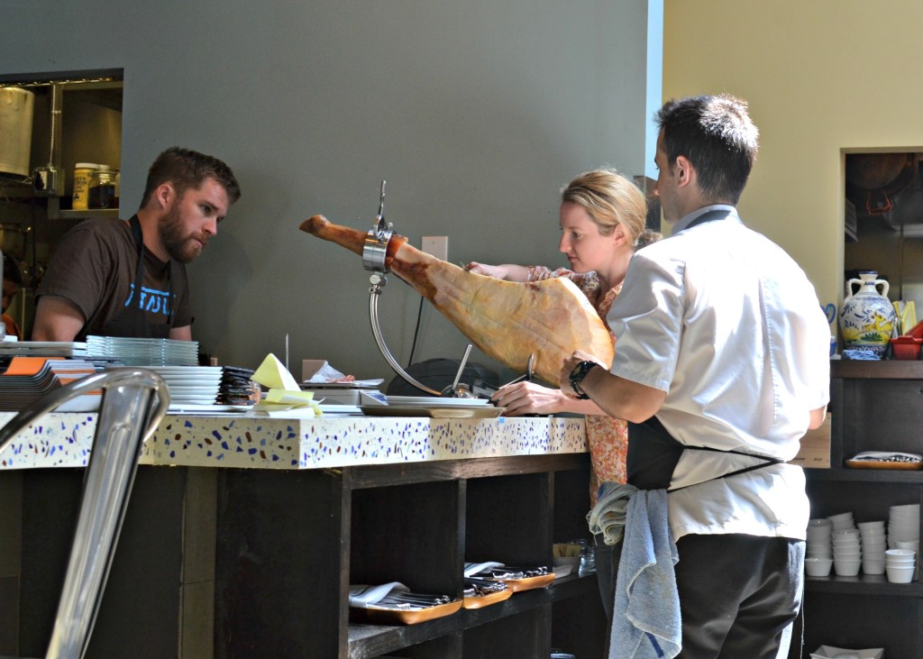 Chef Jose Chesa instructing the staff on how to slice their large Spanish ham.